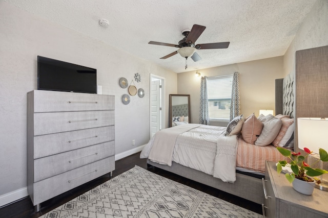 1225 Dumont Dr, Richardson, TX 75080 - bedroom with a textured ceiling, baseboards, ceiling fan, and dark wood-style flooring