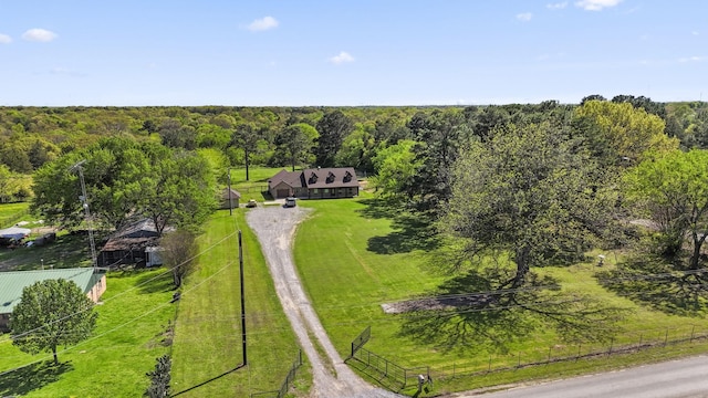 aerial view of property and surrounding area featuring a heavily wooded area