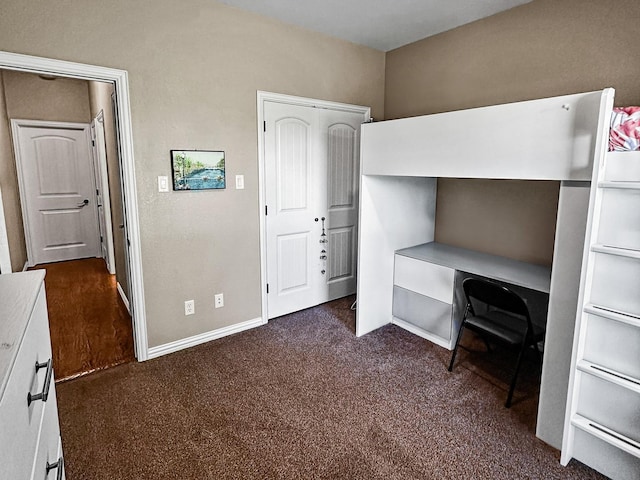 300 Cleve Cole Rd, Denison, TX 75021 - unfurnished bedroom with dark carpet, baseboards, and an office area