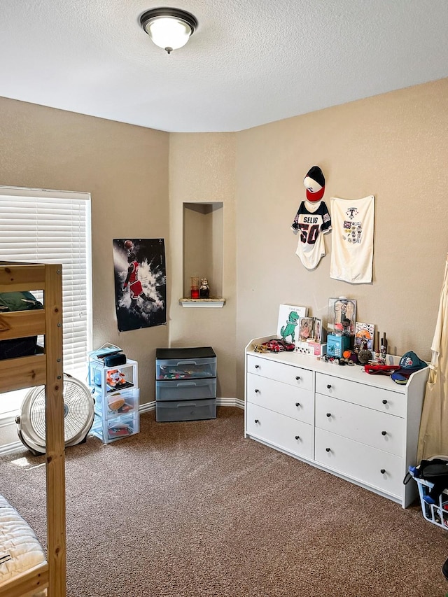 carpeted bedroom featuring a textured ceiling