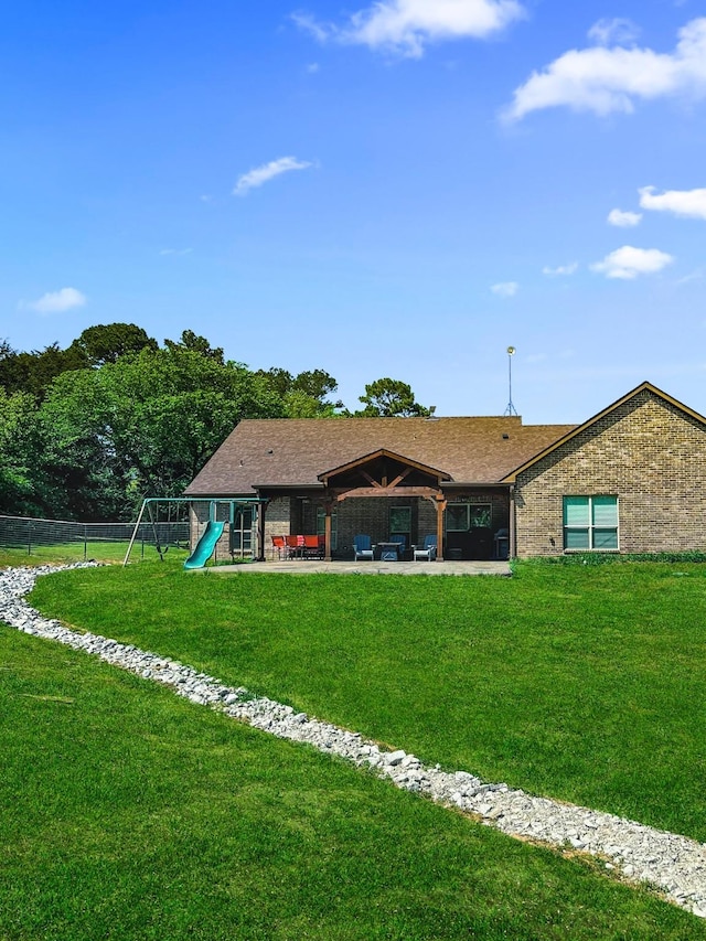 back of house with a playground and a patio