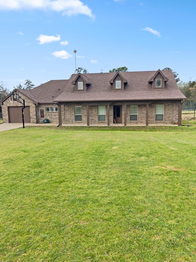 view of property featuring a front yard, brick siding, a shingled roof, and driveway