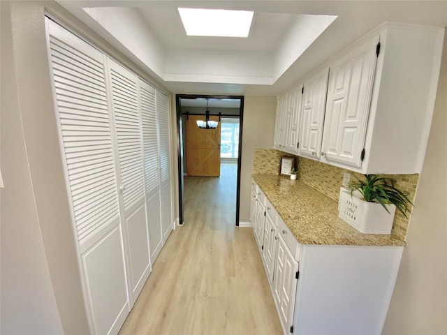1332 Burmeister Rd, Fort Worth, TX 76134 - corridor featuring light wood-type flooring and a raised ceiling