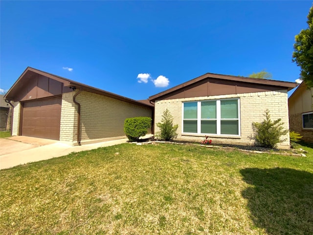1332 Burmeister Rd, Fort Worth, TX 76134 - view of front of house featuring a front yard, an attached garage, brick siding, and concrete driveway