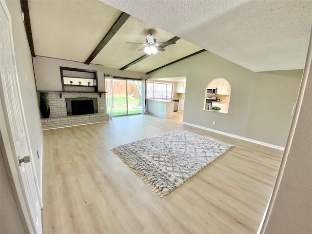 1332 Burmeister Rd, Fort Worth, TX 76134 - living room featuring light wood-type flooring, lofted ceiling with beams, a textured ceiling, and ceiling fan