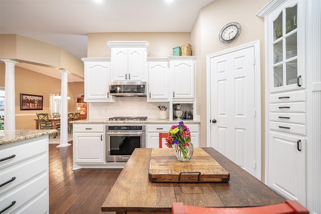 1022 High Meadow Dr, Mount Vernon, TX 75457 - kitchen with white cabinetry, tasteful backsplash, dark wood-style floors, stainless steel appliances, and ornate columns