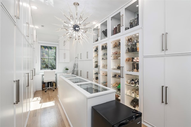 3512 Willow Bend Dr, Plano, TX 75093 - walk in closet featuring light wood-type flooring and a notable chandelier