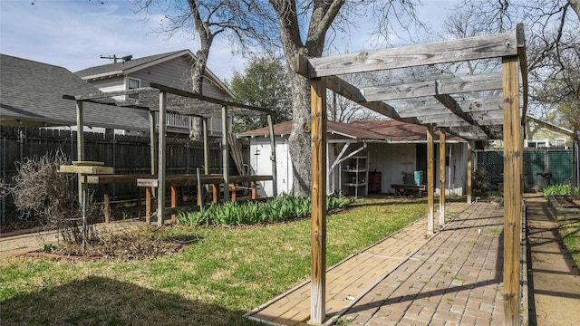 view of yard with a fenced backyard, an outbuilding, a storage shed, a patio area, and a pergola