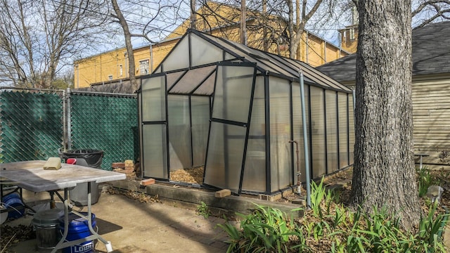 view of greenhouse featuring fence