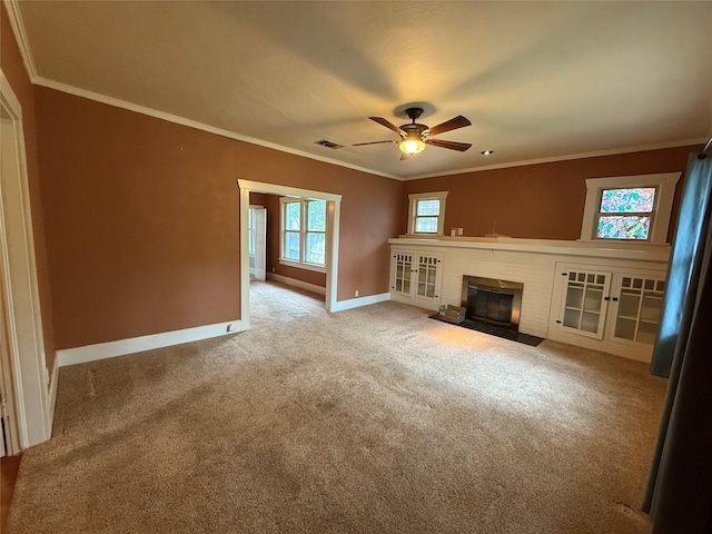 unfurnished living room with a fireplace, carpet flooring, baseboards, visible vents, and a ceiling fan