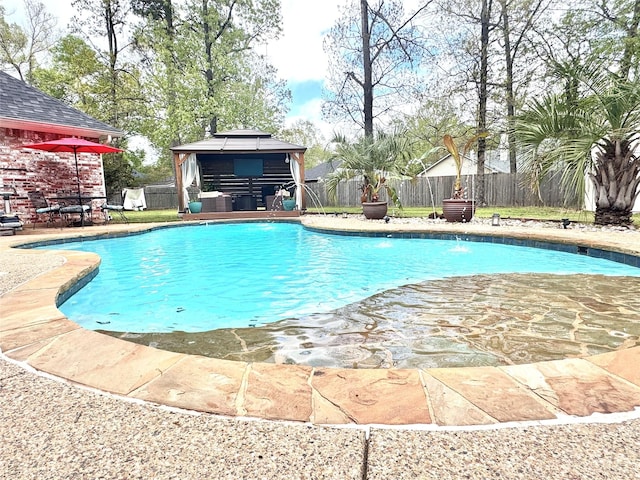 view of swimming pool featuring a gazebo, a fenced backyard, a fenced in pool, and a patio area