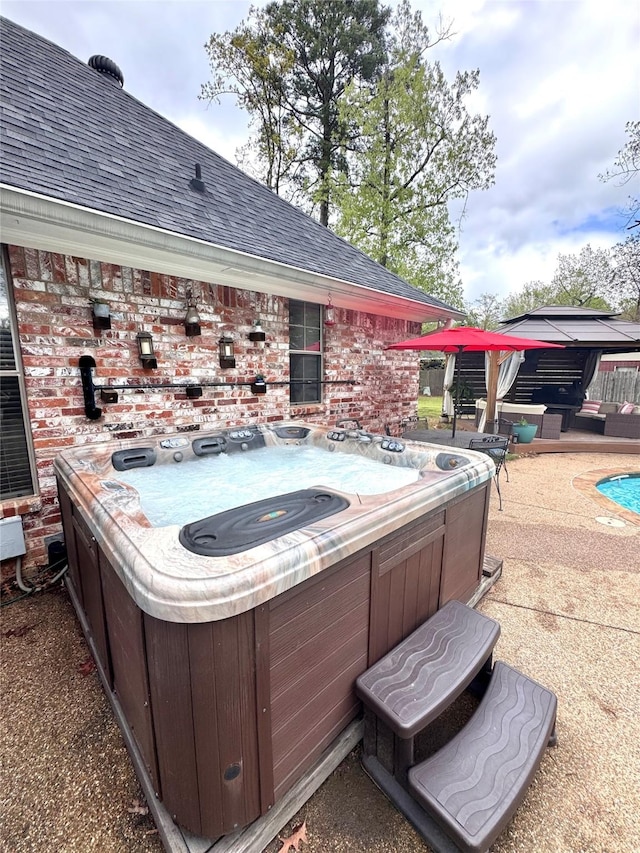 view of patio / terrace featuring a hot tub