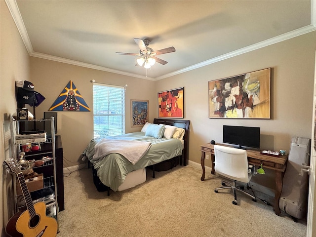 carpeted bedroom with crown molding, baseboards, and a ceiling fan