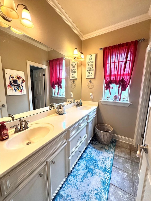 full bathroom featuring crown molding, double vanity, a sink, and baseboards