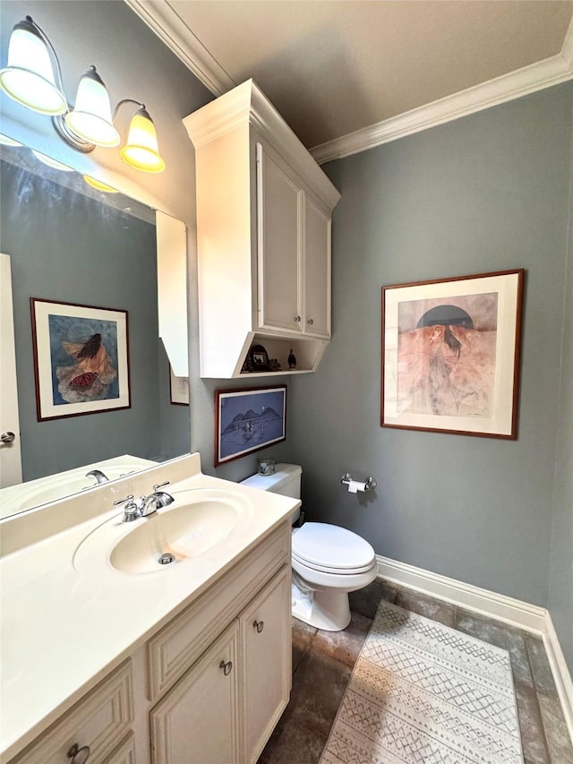 half bathroom featuring toilet, crown molding, vanity, and baseboards