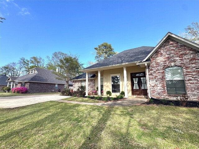 view of front of property featuring a front lawn and brick siding
