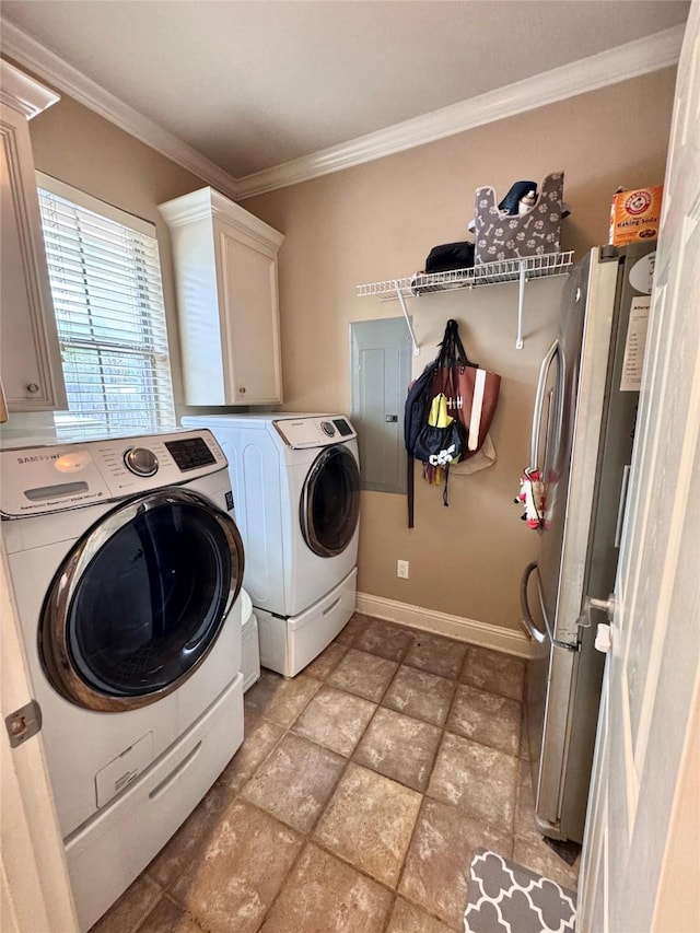 laundry room featuring separate washer and dryer, baseboards, ornamental molding, stone finish floor, and cabinet space