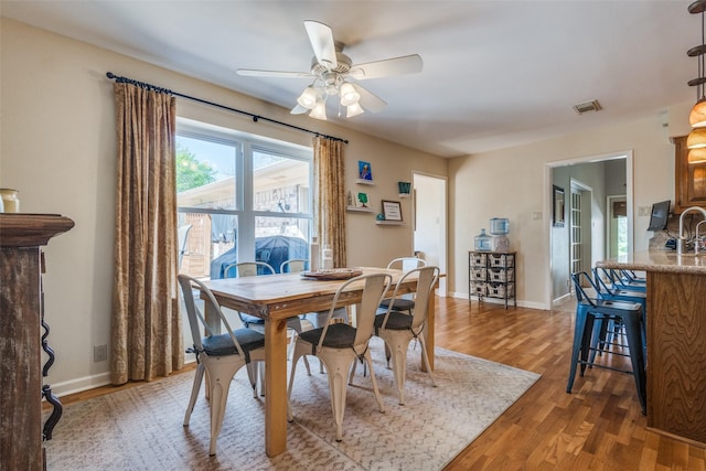 328 S Jackson Ave, Justin, TX 76247 - dining space featuring light wood-style flooring, a ceiling fan, and baseboards
