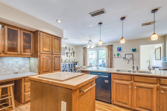 328 S Jackson Ave, Justin, TX 76247 - kitchen featuring dishwasher, a sink, a kitchen island, brown cabinets, and recessed lighting