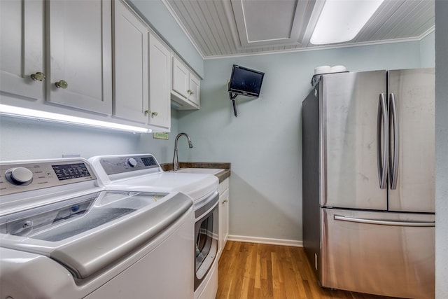 328 S Jackson Ave, Justin, TX 76247 - washroom with light wood-style floors, baseboards, and separate washer and dryer