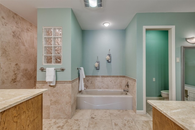 328 S Jackson Ave, Justin, TX 76247 - bathroom featuring tile walls, a bath, toilet, tile patterned floors, and vanity