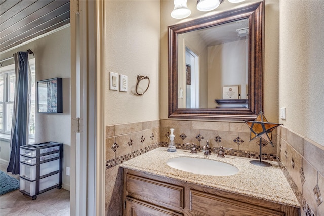 328 S Jackson Ave, Justin, TX 76247 - bathroom featuring vanity, tile patterned flooring, and a textured wall