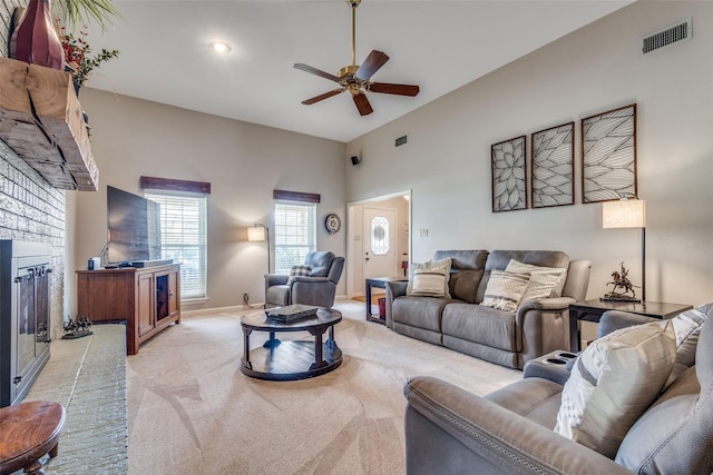 328 S Jackson Ave, Justin, TX 76247 - living room featuring light colored carpet, a ceiling fan, a brick fireplace, and baseboards