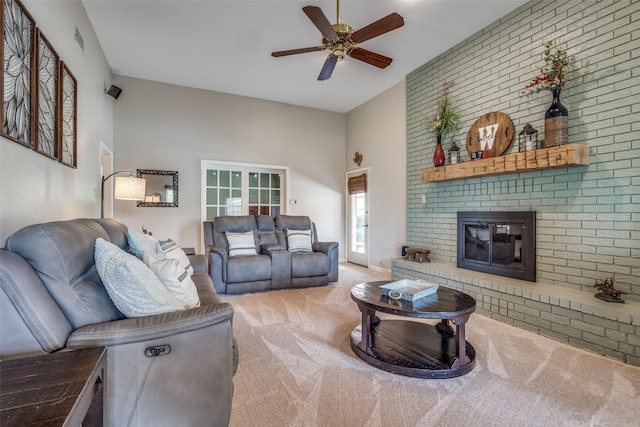328 S Jackson Ave, Justin, TX 76247 - carpeted living area featuring ceiling fan, a fireplace, and a high ceiling