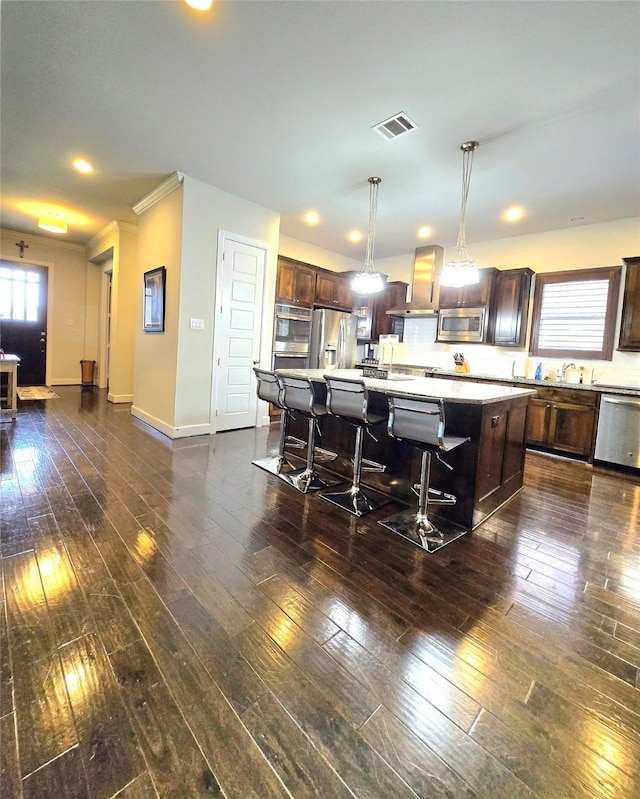 1214 Norwood St, Mansfield, TX 76063 - kitchen with wall chimney range hood, stainless steel appliances, dark brown cabinetry, and dark wood-type flooring