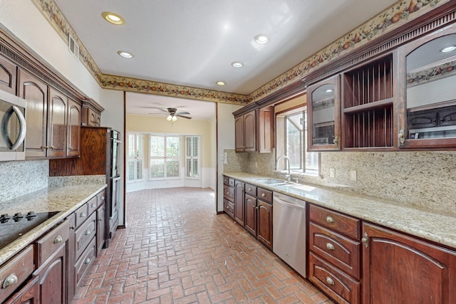 102 Cedar Dr, Oak Leaf, TX 75154 - kitchen with brick floor, decorative backsplash, a sink, and stainless steel appliances