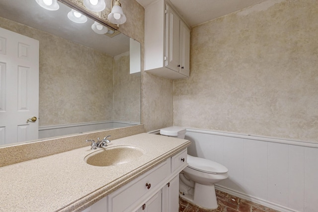 102 Cedar Dr, Oak Leaf, TX 75154 - bathroom with a wainscoted wall, toilet, and vanity