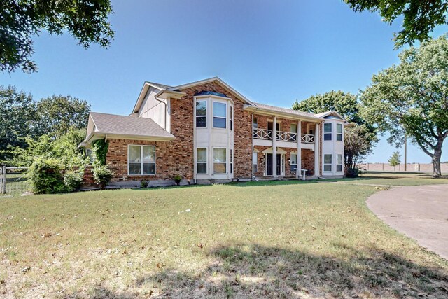 102 Cedar Dr, Oak Leaf, TX 75154 - view of front of house with a balcony, fence, a front lawn, and brick siding