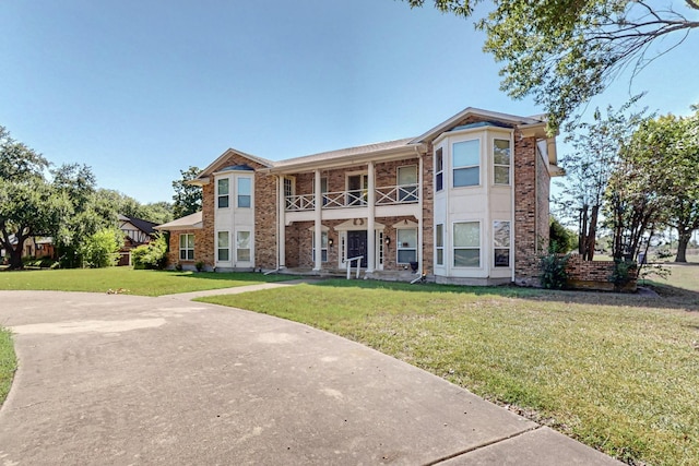 102 Cedar Dr, Oak Leaf, TX 75154 - view of property featuring a front lawn, a balcony, and brick siding