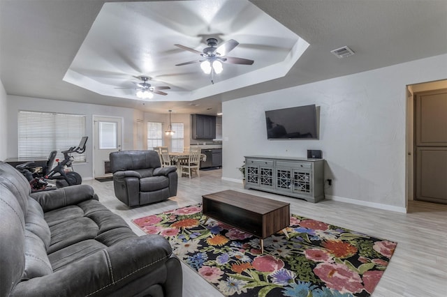 509 Brockett St, Aubrey, TX 76227 - living area with a raised ceiling, ceiling fan, light wood-style flooring, and baseboards