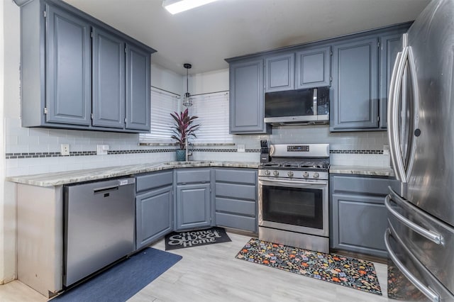 509 Brockett St, Aubrey, TX 76227 - kitchen with stainless steel appliances, a sink, decorative backsplash, and decorative light fixtures
