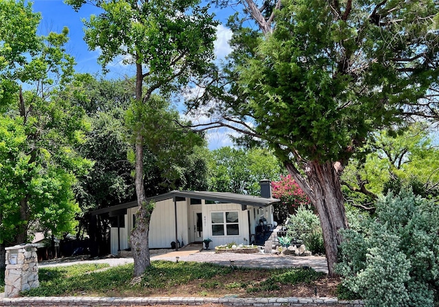 4901 Fairway Ct, De Cordova, TX 76049 - mid-century modern home featuring board and batten siding and a chimney