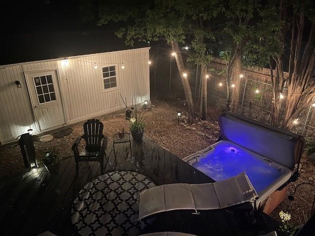 4901 Fairway Ct, De Cordova, TX 76049 - pool at night featuring an outdoor structure and a covered hot tub