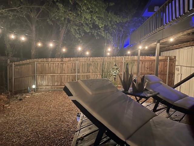 4901 Fairway Ct, De Cordova, TX 76049 - patio at night featuring a fenced backyard