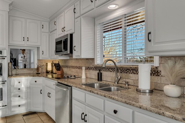 4901 Fairway Ct, De Cordova, TX 76049 - kitchen with white cabinets, a sink, appliances with stainless steel finishes, and light tile patterned flooring