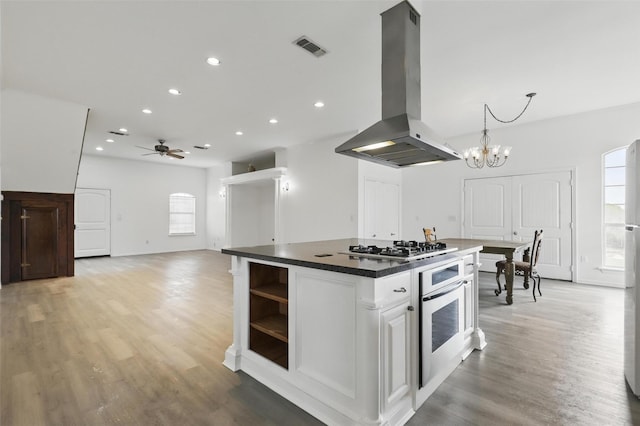 kitchen with visible vents, stainless steel appliances, dark countertops, island range hood, and open shelves