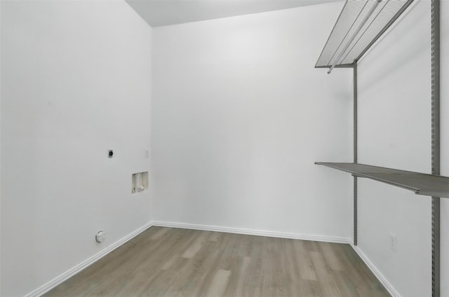 clothes washing area featuring washer hookup, wood finished floors, electric dryer hookup, laundry area, and baseboards
