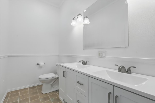 bathroom featuring double vanity, toilet, a sink, and tile patterned floors