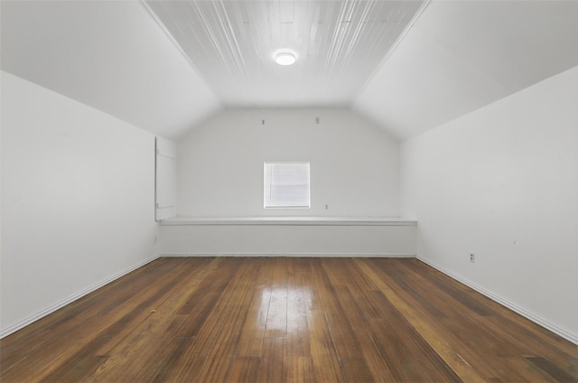 additional living space with vaulted ceiling and hardwood / wood-style floors