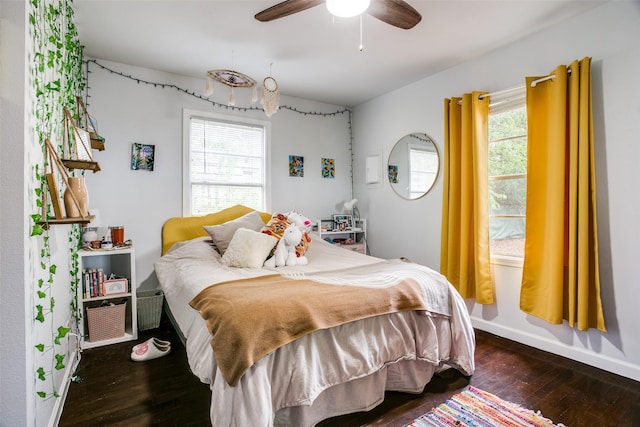 bedroom featuring baseboards, a ceiling fan, and wood-type flooring