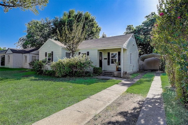 view of front of property with a front yard and a carport