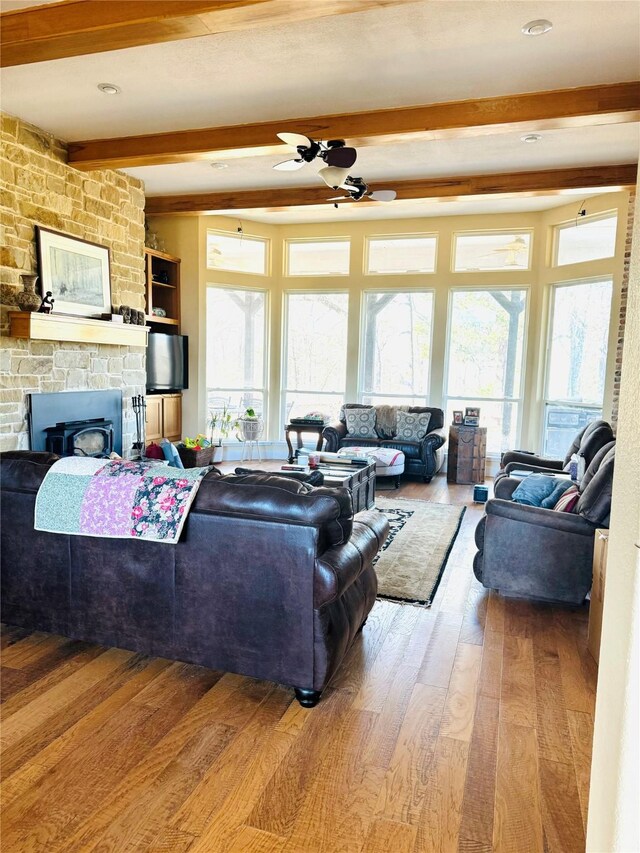 living area featuring hardwood / wood-style floors, ceiling fan, and plenty of natural light