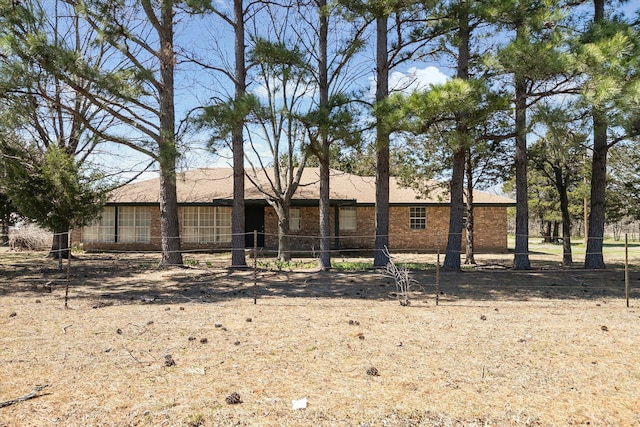 ranch-style house featuring brick siding
