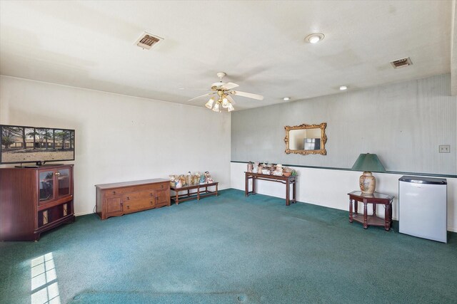 living area with carpet flooring, a ceiling fan, and visible vents