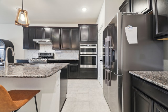 342 Meredith Dr, Fate, TX 75087 - kitchen featuring appliances with stainless steel finishes, decorative backsplash, dark stone countertops, a sink, and light tile patterned floors