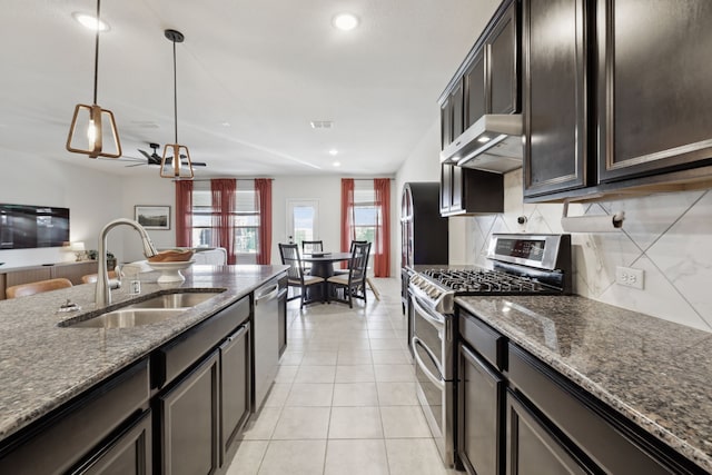 342 Meredith Dr, Fate, TX 75087 - kitchen featuring appliances with stainless steel finishes, a sink, exhaust hood, decorative backsplash, and dark stone countertops